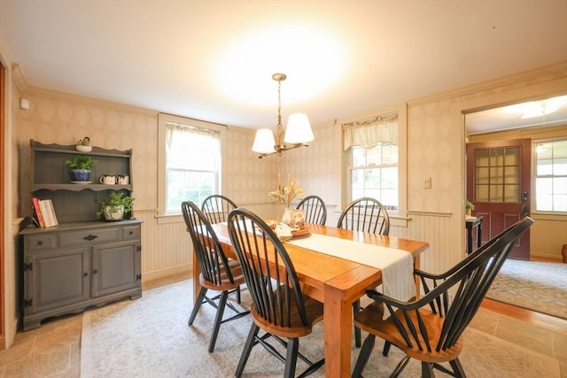 21 Witherell Pl, Plainville, MA 02762 - dining space featuring wallpapered walls, a wainscoted wall, crown molding, a chandelier, and light stone finish floors