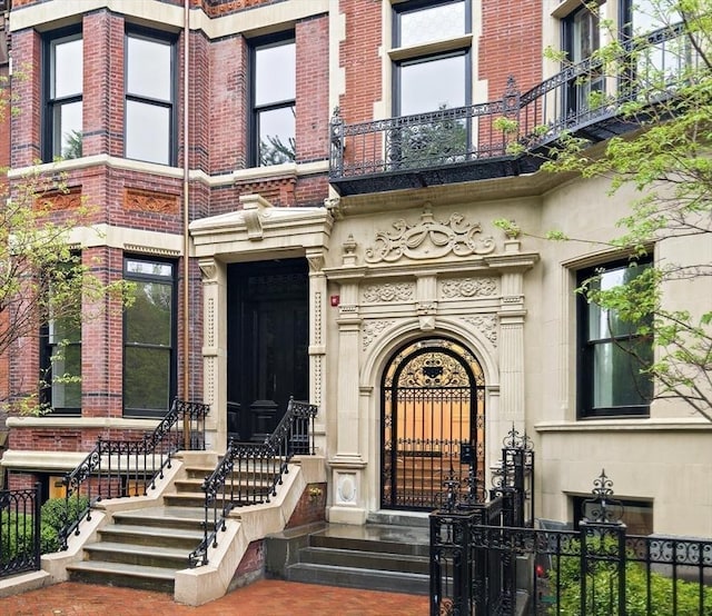 240 Commonwealth Ave Unit 2, Boston, MA 02116 - doorway to property with fence, a balcony, stone siding, and brick siding