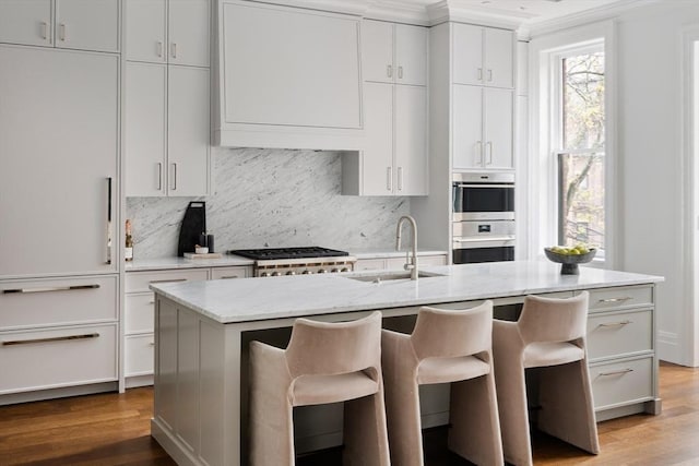 240 Commonwealth Ave Unit 2, Boston, MA 02116 - kitchen with a sink, wood finished floors, double oven, decorative backsplash, and crown molding