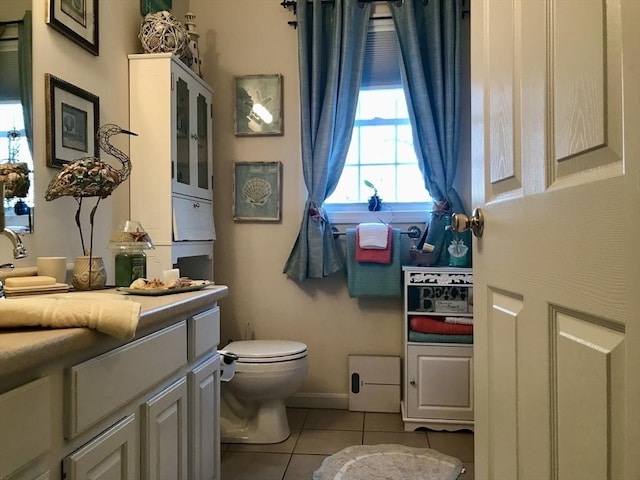 bathroom featuring vanity, toilet, and tile patterned flooring