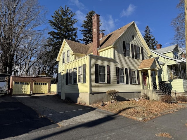 view of front facade featuring an outbuilding and a garage