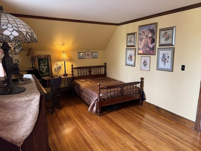 bedroom with hardwood / wood-style flooring and crown molding