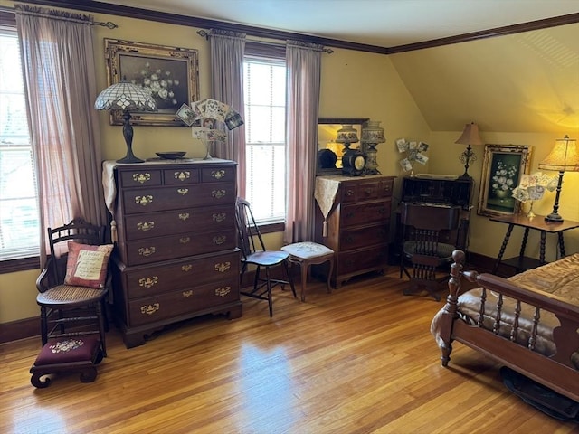 bedroom with lofted ceiling, ornamental molding, and light wood-type flooring