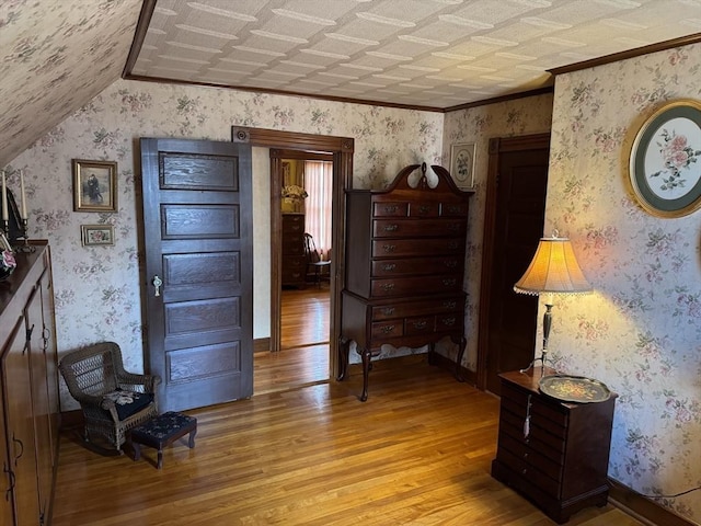 unfurnished room featuring ornamental molding and light hardwood / wood-style flooring