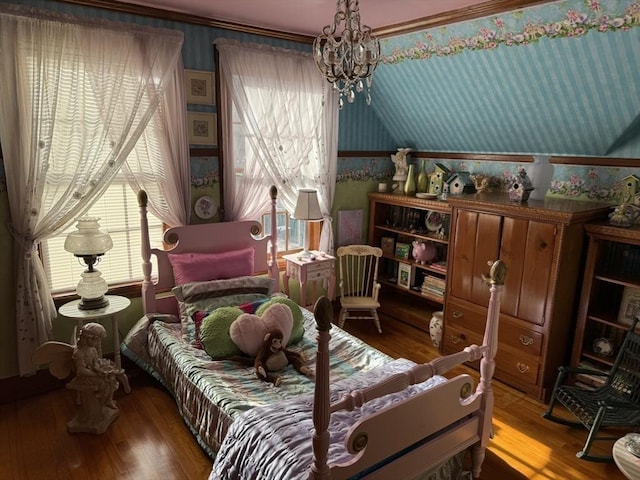 bedroom featuring multiple windows, hardwood / wood-style flooring, and a chandelier