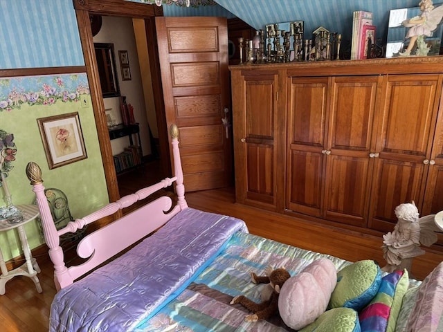 bedroom with hardwood / wood-style flooring