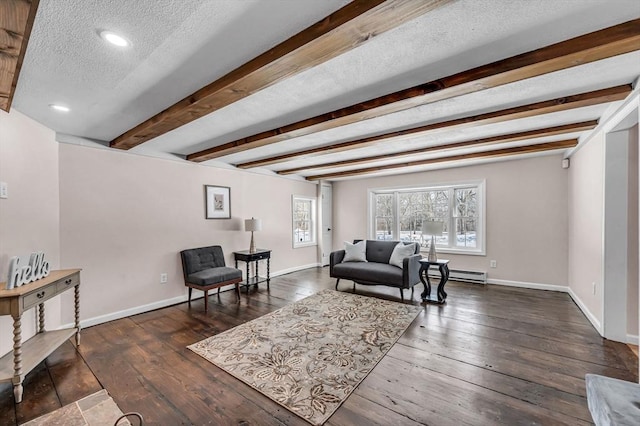 living area featuring a textured ceiling, a baseboard heating unit, baseboards, dark wood-style floors, and beamed ceiling