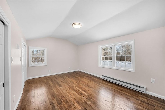 unfurnished bedroom with dark wood-type flooring, a baseboard radiator, multiple windows, and lofted ceiling