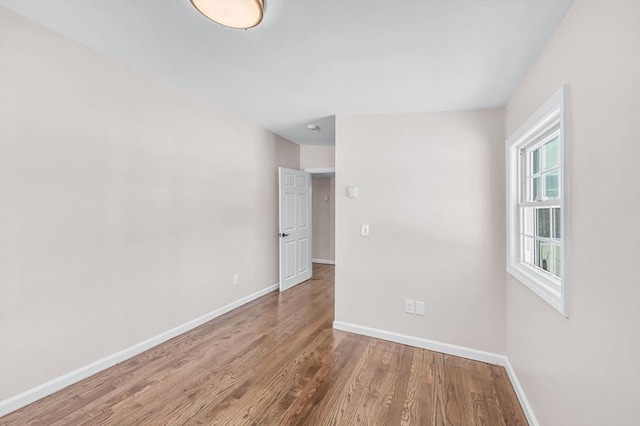 spare room with light wood-style flooring and baseboards