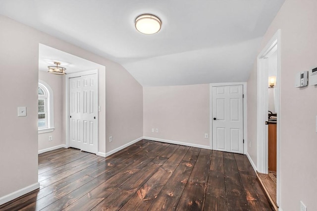 bonus room featuring lofted ceiling, dark wood finished floors, and baseboards