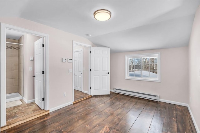 unfurnished bedroom with lofted ceiling, baseboards, baseboard heating, and dark wood-type flooring