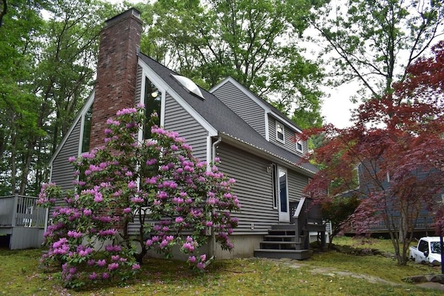 16 Sherborne Cir, Ashland, MA 01721 - view of side of home featuring a chimney, a deck, and a shingled roof