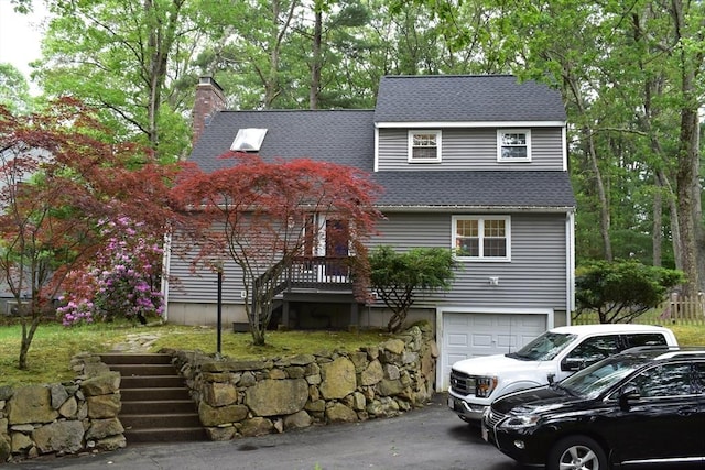 16 Sherborne Cir, Ashland, MA 01721 - view of front of house with an attached garage, a chimney, asphalt driveway, and roof with shingles