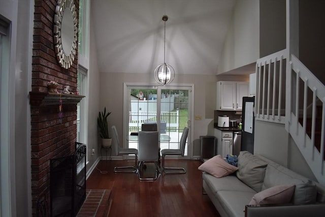 16 Sherborne Cir, Ashland, MA 01721 - living room featuring dark wood-type flooring, lofted ceiling, stairs, a chandelier, and baseboards