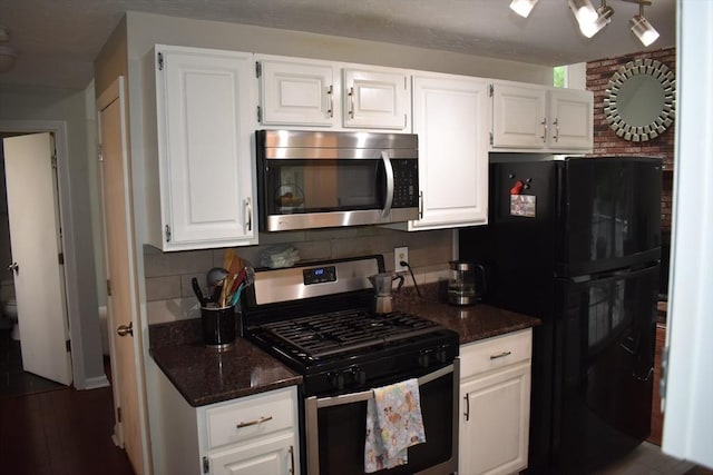 16 Sherborne Cir, Ashland, MA 01721 - kitchen with stainless steel appliances, dark stone counters, and white cabinetry