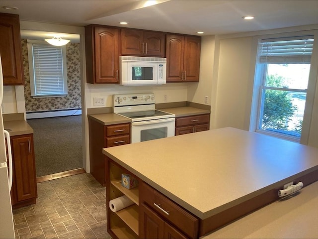 kitchen with recessed lighting, light countertops, a baseboard radiator, and white appliances