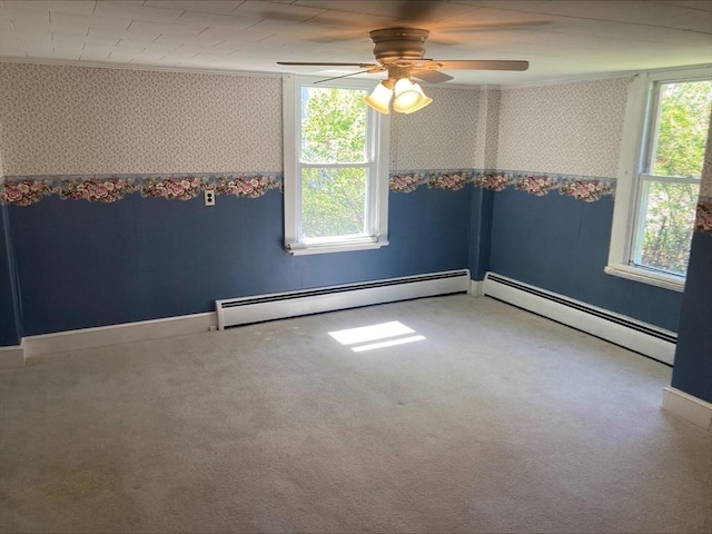 carpeted spare room featuring ceiling fan, baseboard heating, and wallpapered walls