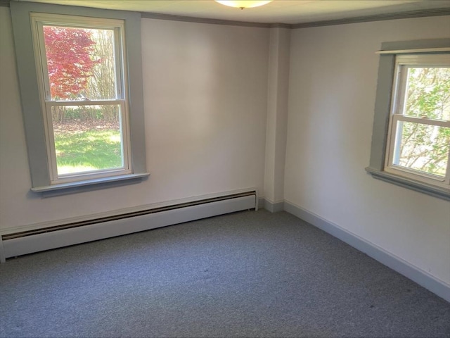 unfurnished room featuring carpet floors, ornamental molding, and a baseboard heating unit