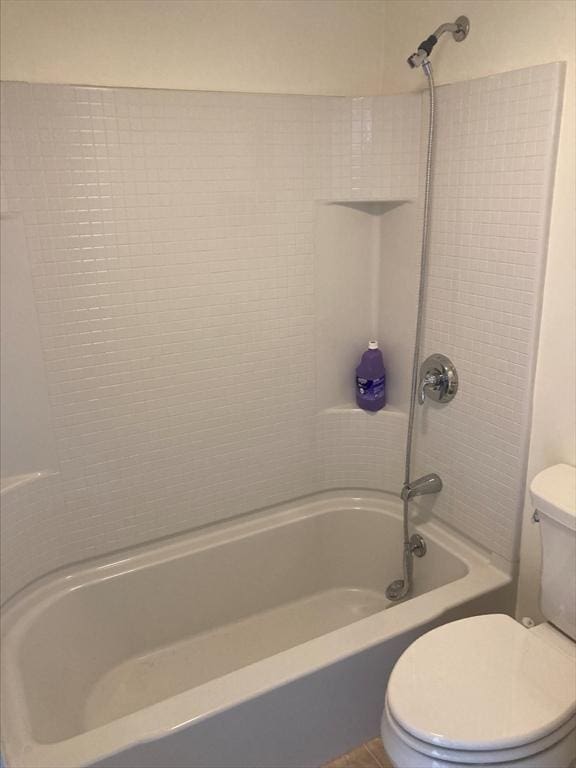 bathroom with bathing tub / shower combination and toilet