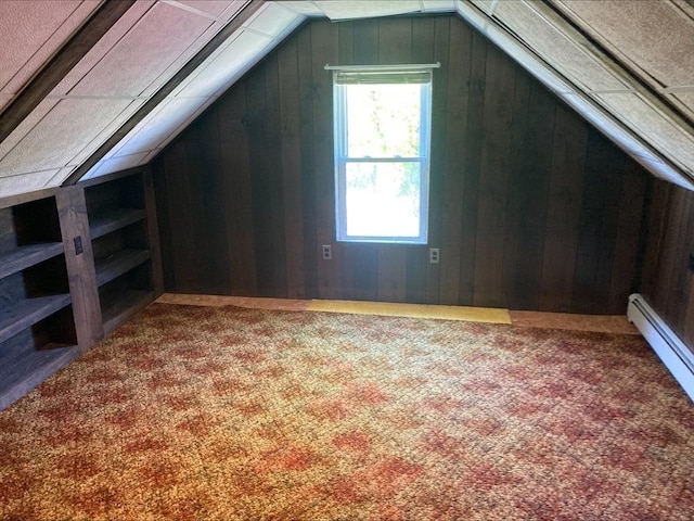 additional living space featuring wooden walls, carpet flooring, and lofted ceiling