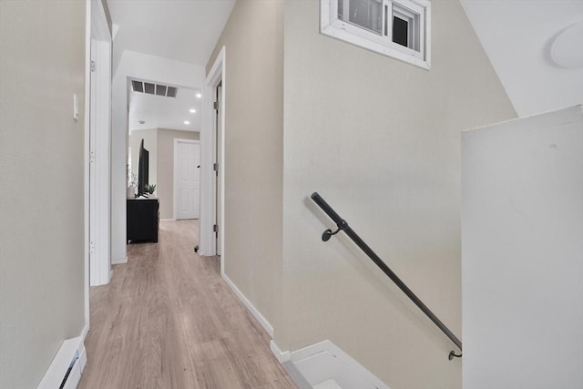 32 Slater St, Fall River, MA 02720 - hallway featuring an upstairs landing, a baseboard heating unit, and light wood finished floors