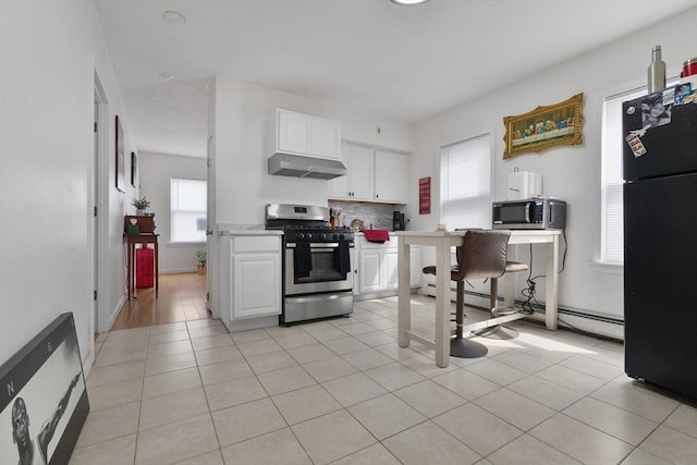 32 Slater St, Fall River, MA 02720 - kitchen featuring stainless steel appliances, exhaust hood, white cabinetry, and decorative backsplash