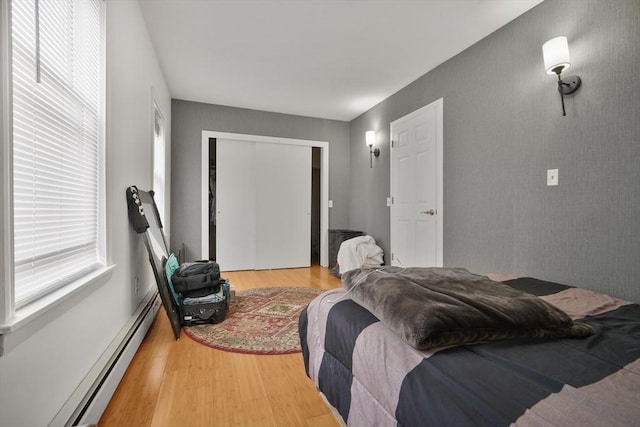 32 Slater St, Fall River, MA 02720 - bedroom featuring wood finished floors, a closet, and baseboard heating