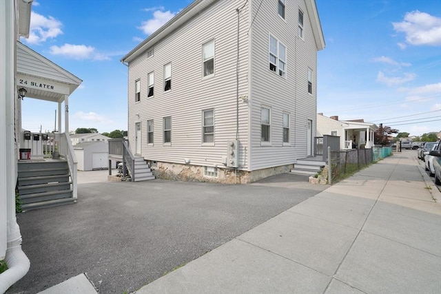 32 Slater St, Fall River, MA 02720 - view of side of home featuring a storage unit and a residential view