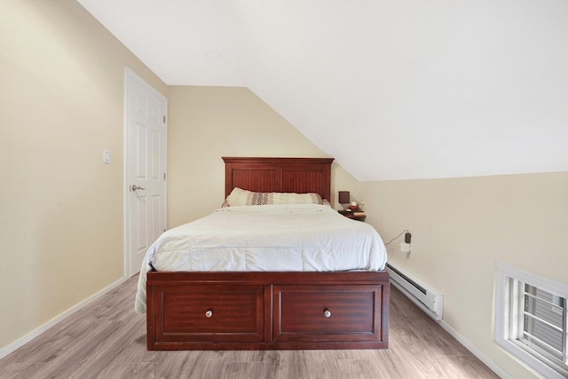 32 Slater St, Fall River, MA 02720 - bedroom featuring baseboard heating, light wood-style floors, and lofted ceiling