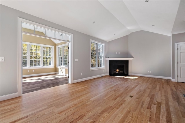 unfurnished living room with light hardwood / wood-style flooring and vaulted ceiling