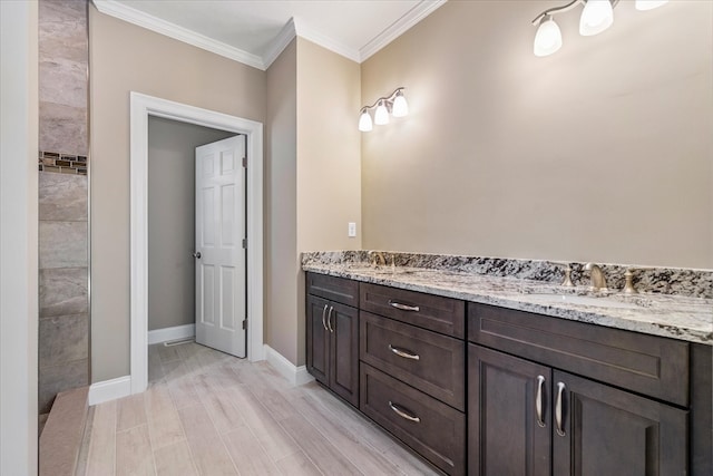 bathroom with ornamental molding, hardwood / wood-style floors, and vanity