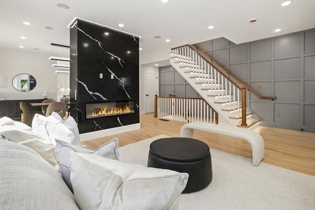 45 Sargent Ave Unit 45, Somerville, MA 02145 - living area with light wood-style floors, a decorative wall, stairs, recessed lighting, and a large fireplace