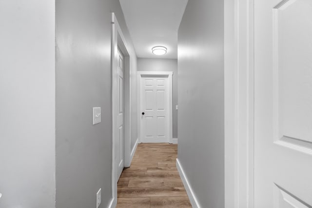 corridor with light hardwood / wood-style flooring