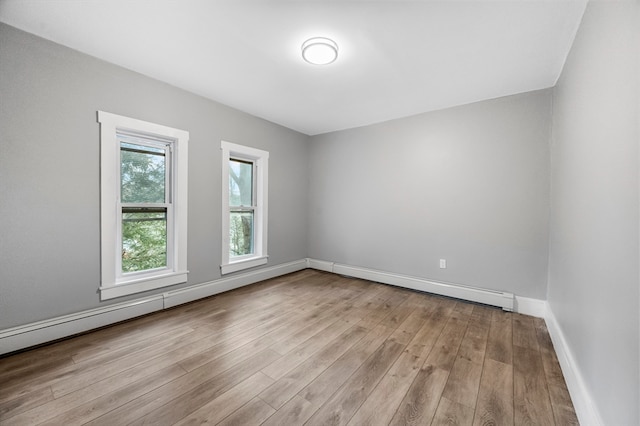 empty room featuring light hardwood / wood-style flooring and baseboard heating