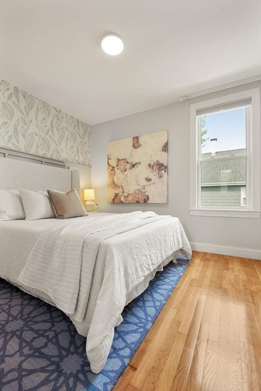 34 Leniston St Unit 2, Boston, MA 02131 - bedroom with hardwood / wood-style flooring, wallpapered walls, and baseboards