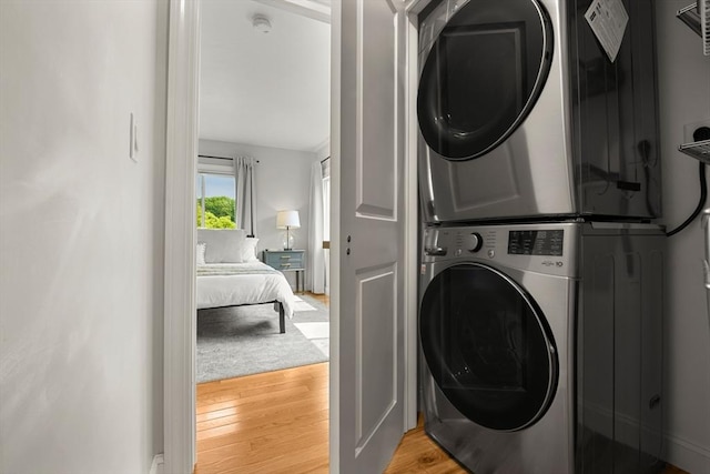 34 Leniston St Unit 2, Boston, MA 02131 - washroom with estacked washer and dryer and light wood-style floors