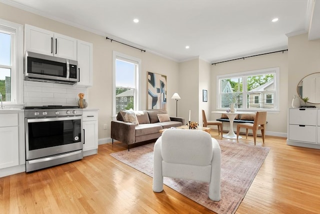 34 Leniston St Unit 2, Boston, MA 02131 - living area with ornamental molding, light wood finished floors, recessed lighting, and baseboards