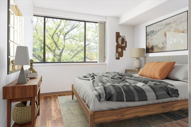 169 Monsignor Obrien Hwy Unit 206, Cambridge, MA 02141 - bedroom with multiple windows, wood finished floors, and baseboards