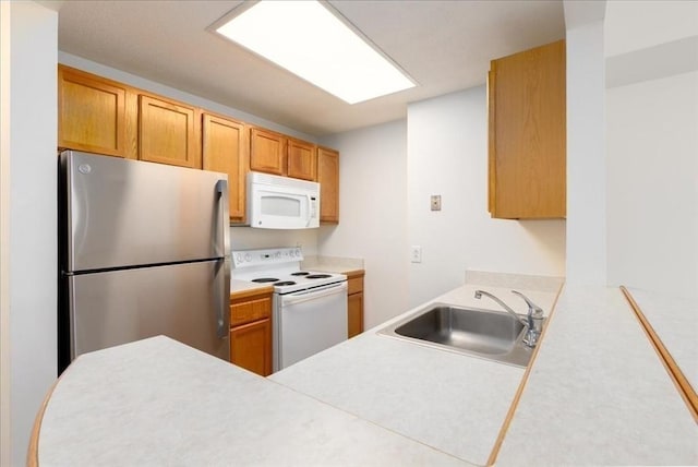 169 Monsignor Obrien Hwy Unit 206, Cambridge, MA 02141 - kitchen with white appliances, a sink, light countertops, and a peninsula