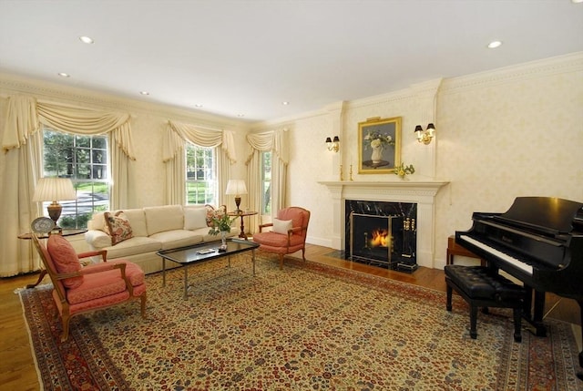living area featuring crown molding, recessed lighting, a high end fireplace, and wood finished floors