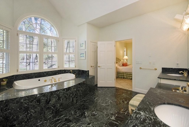 full bathroom with marble finish floor, vanity, ensuite bath, high vaulted ceiling, and a bath