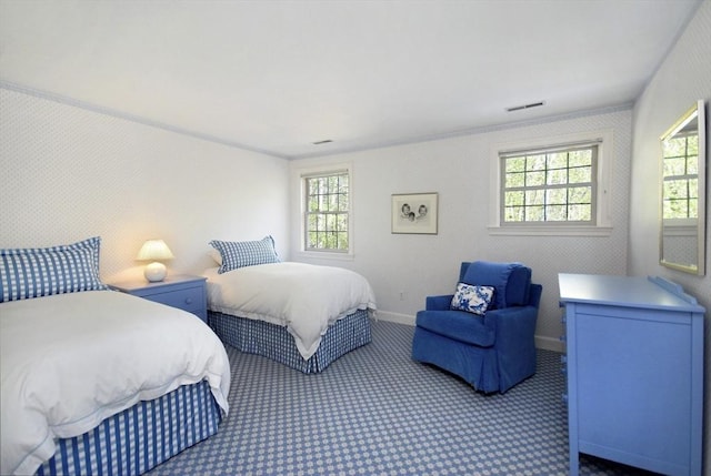 carpeted bedroom featuring visible vents and baseboards