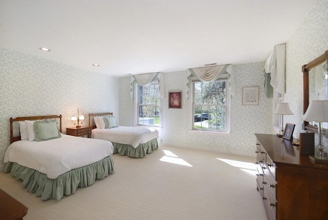 carpeted bedroom with wallpapered walls