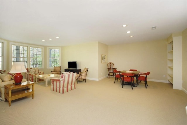 living area featuring light carpet, baseboards, and recessed lighting