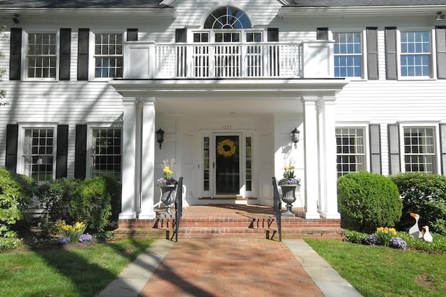 property entrance with a porch and a balcony