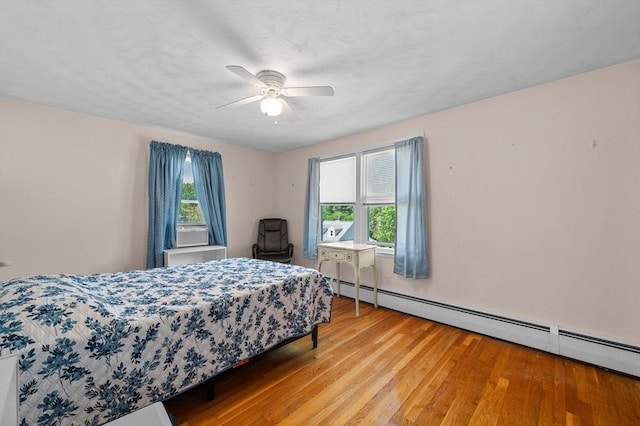 22 Edgewood Ave, West Boylston, MA 01583 - bedroom with a baseboard heating unit, light wood finished floors, multiple windows, and cooling unit