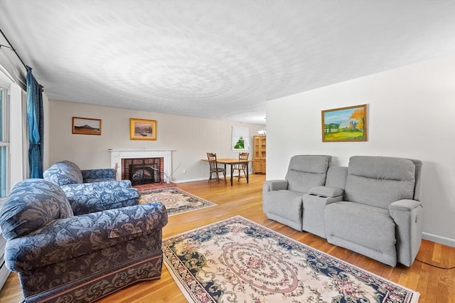22 Edgewood Ave, West Boylston, MA 01583 - living area featuring light wood-style flooring and a fireplace