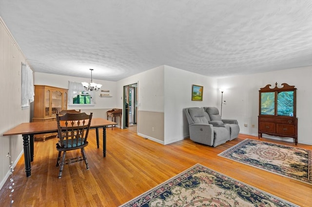22 Edgewood Ave, West Boylston, MA 01583 - living area featuring a chandelier, a textured ceiling, and light wood-type flooring