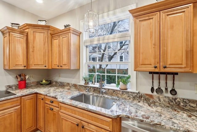 kitchen with a sink, decorative light fixtures, stainless steel dishwasher, brown cabinetry, and light stone countertops