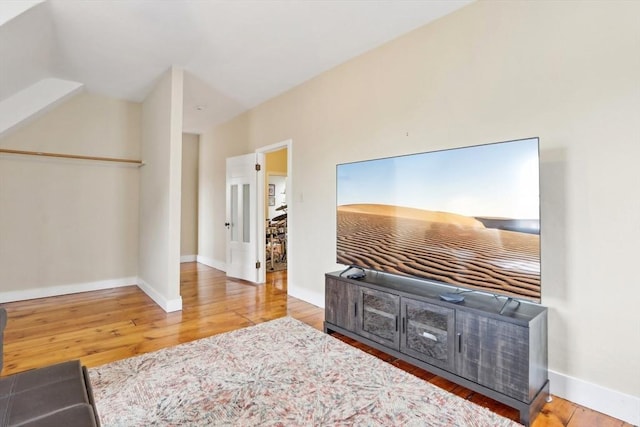 interior space featuring baseboards and wood-type flooring